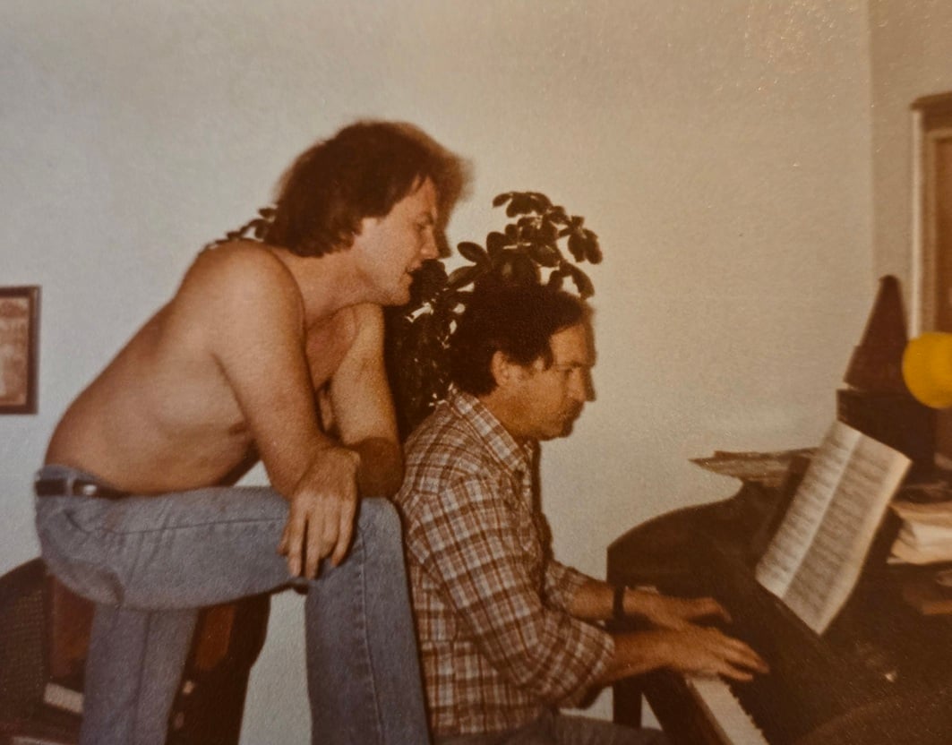 T. Eric Hart singing with his father at the piano